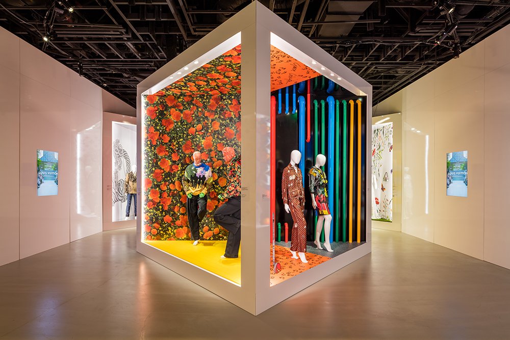 Gallery cube with mannequins in floral and striped looks set against bright coloured backdrops.